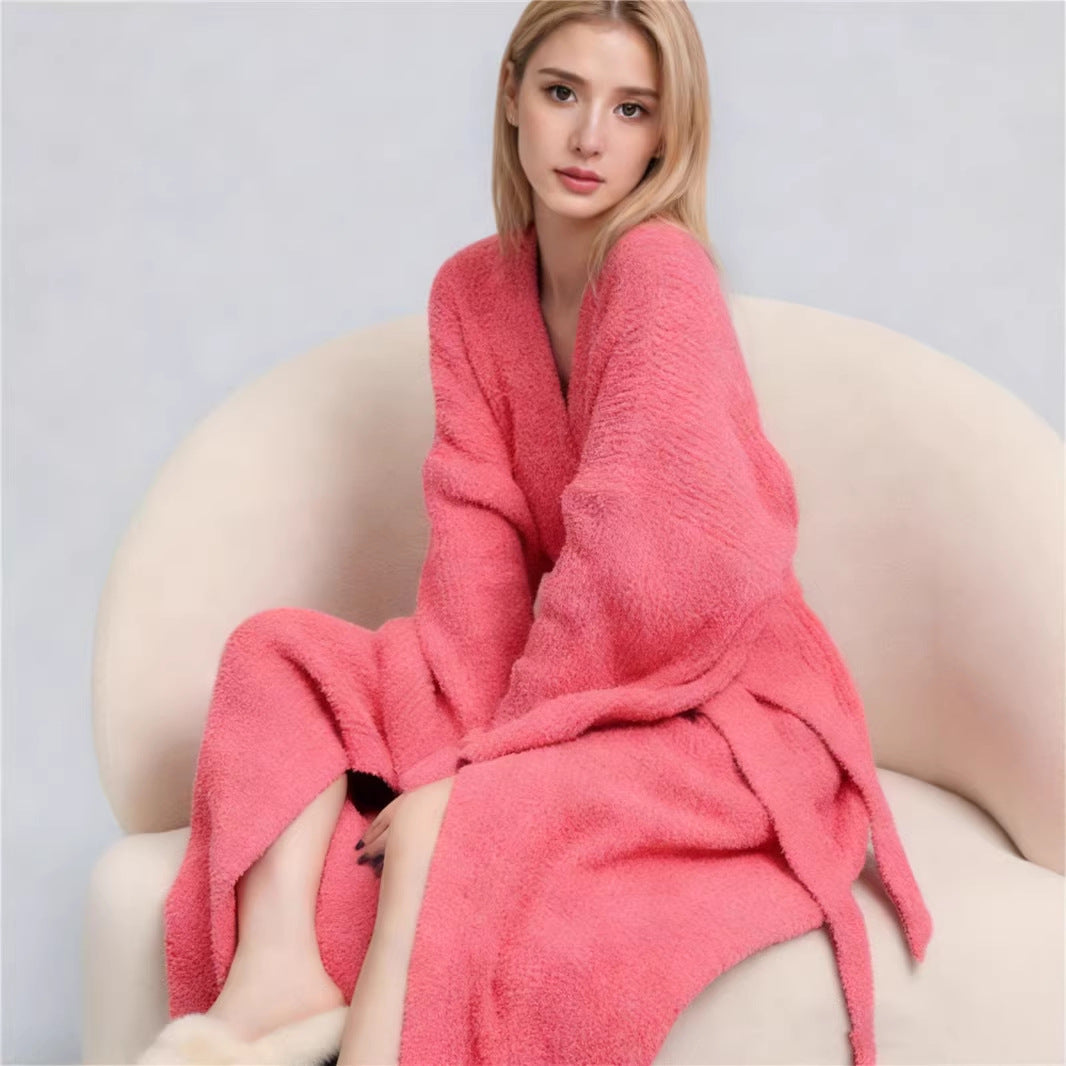 Long robe in Salmon worn seated in a rounded cream armchair