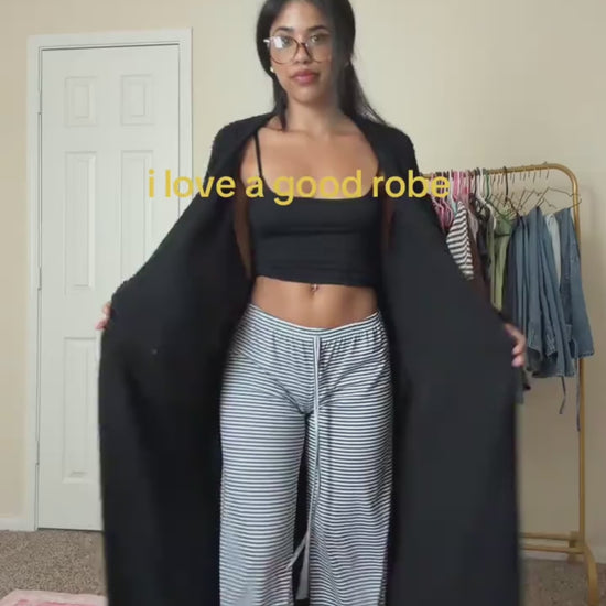 Woman opening the long robe in Onyx to show its length