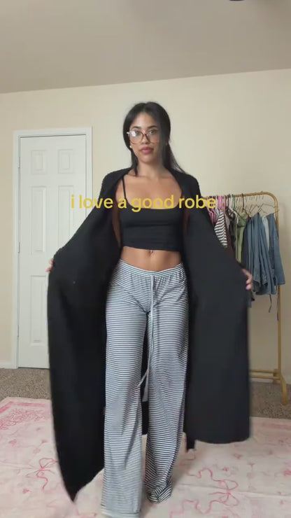 Woman opening the long robe in Onyx to show its length