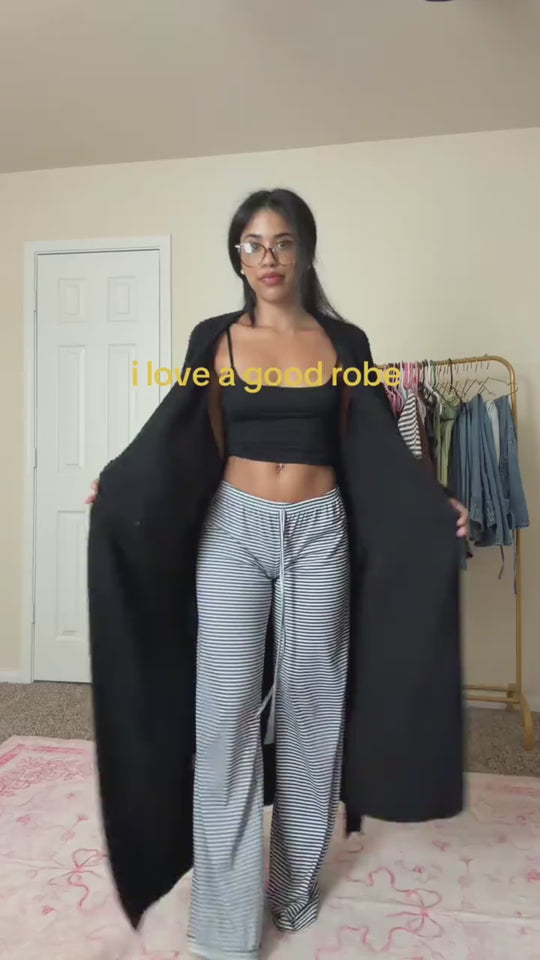 Woman opening the long robe in Onyx to show its length