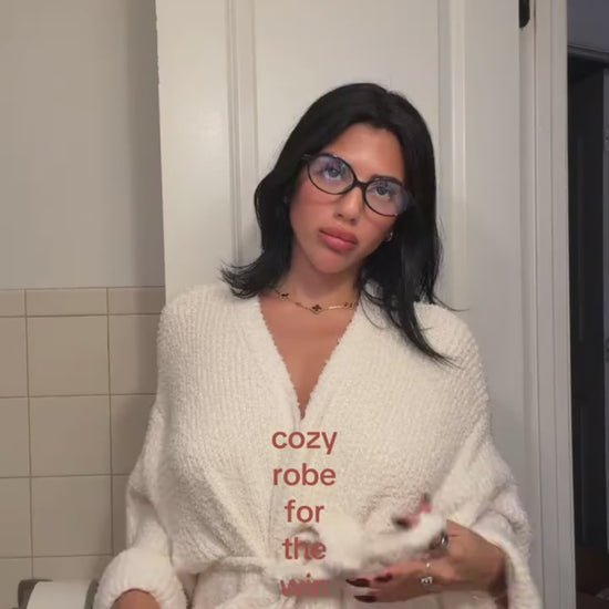 Woman tying the belt of the long robe in Ivory