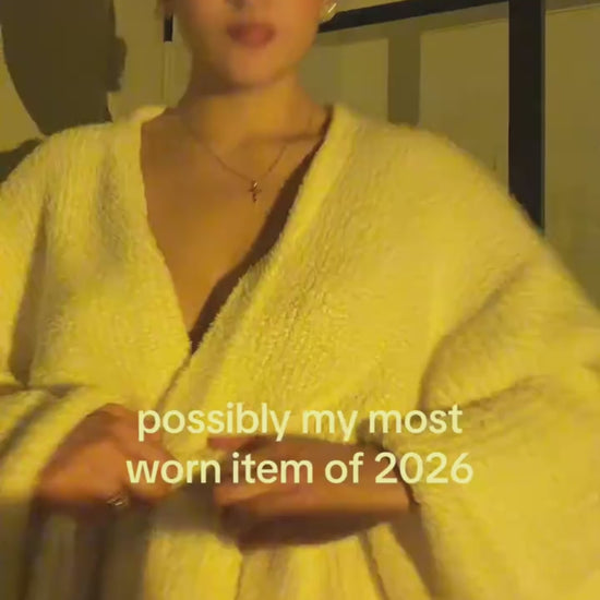 Woman adjusting the long robe in Ivory at home