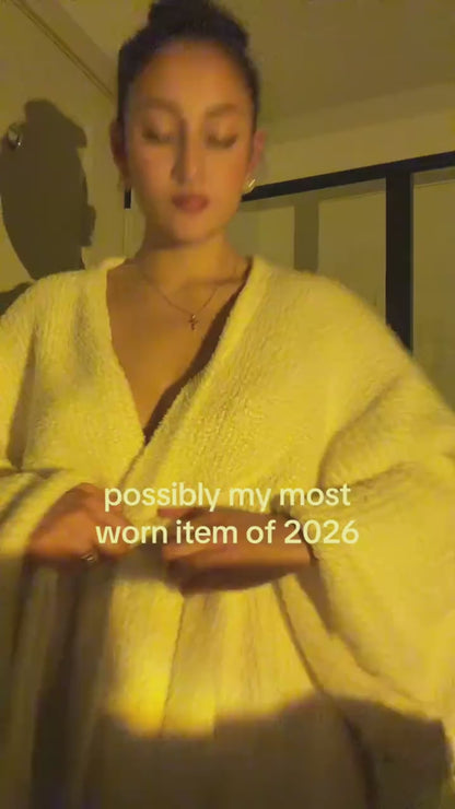 Woman adjusting the long robe in Ivory at home
