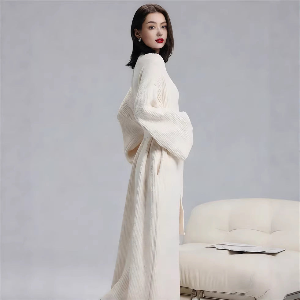 Side view of the long robe in Ivory showing its relaxed full-length silhouette and wide sleeves