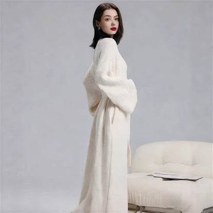 Side view of the long robe in Ivory showing its relaxed full-length silhouette and wide sleeves