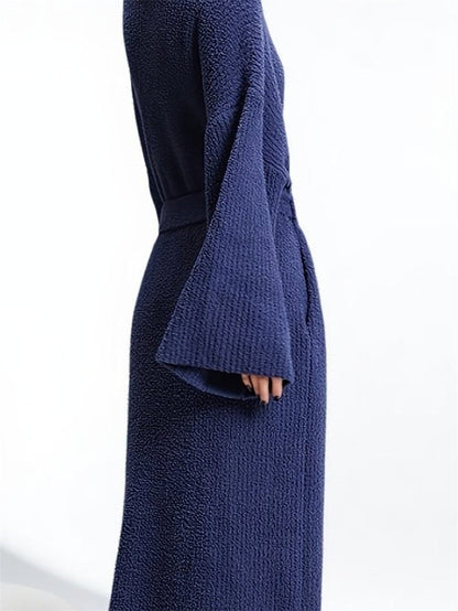 Close-up of the long robe in Lapis showing the textured fabric and wide sleeve